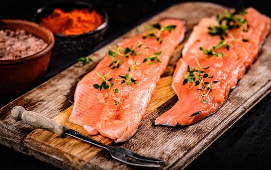 fillet of trout red fish with herbs on a cutting board