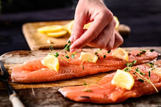 girl decorating at fillet trout red fish for cooking a healthy dinner