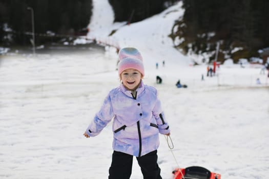 A girl with bob sledding in the snow