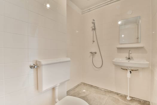 a bathroom with a toilet, sink and mirror on the wall next to it is a white tiled shower stall