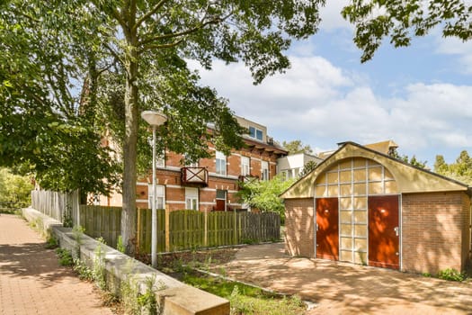 an outside area with some trees and houses in the background, including a red fire hydraous door that is open