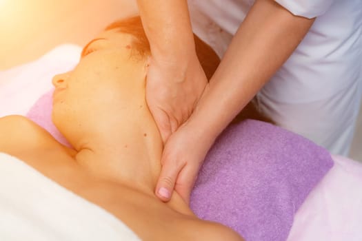 Facial massage. A woman is given a massage in a beauty salon. Close-up