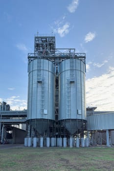 grain storage tanks on a blue sky background. photo