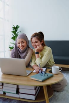 Muslim undergraduates and Asian women are studying online using computers