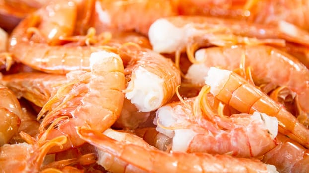 Top view of small red fresh prawns on a fishmonger's stall. Gourmet sea healthy food.