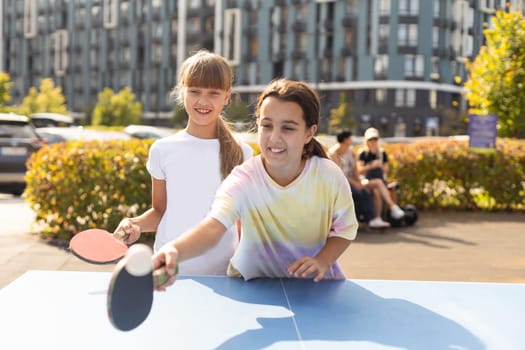 little girl playing table tennis in the tennis hall, tennis racket hitting the ball, the pitch of the ball. High quality photo