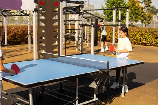 girl plays in table tennis outdoor. High quality photo
