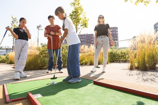 Kids playing golf inside playground artificial grass activity game for children . High quality photo