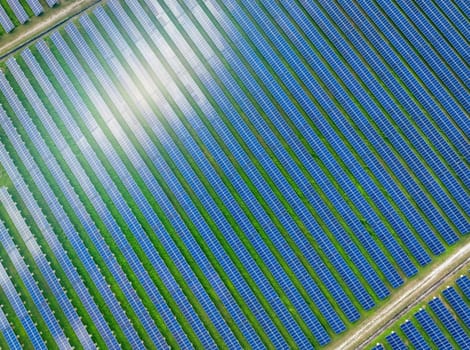 Aerial view of solar farm. Solar power for green energy. Sustainable resources. Solar cell panels use sun light as a source to generate electricity. Photovoltaics or PV. Sustainable renewable energy.