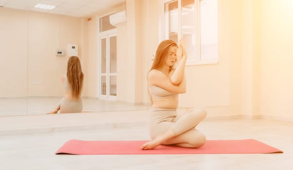 Group of young womans fitness instructor in Sportswear Leggings and Tops, stretching in the gym before pilates, on a yoga mat near the large window on a sunny day, female fitness yoga routine concept.