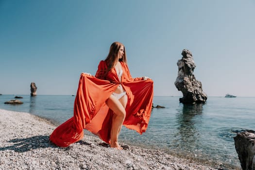 Woman travel sea. Happy tourist taking picture outdoors for memories. Woman traveler looks at the edge of the cliff on the sea bay of mountains, sharing travel adventure journey.