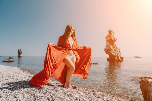 Woman travel sea. Happy tourist taking picture outdoors for memories. Woman traveler looks at the edge of the cliff on the sea bay of mountains, sharing travel adventure journey.