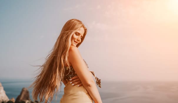 Woman travel sea. Happy tourist taking picture outdoors for memories. Woman traveler looks at the edge of the cliff on the sea bay of mountains, sharing travel adventure journey.