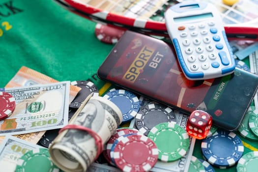 Online poker concept. Smartphone and poker chips on a green background. Poker online banner. Copy space. Vignette. Place for text. Gambling. Background. High quality photo