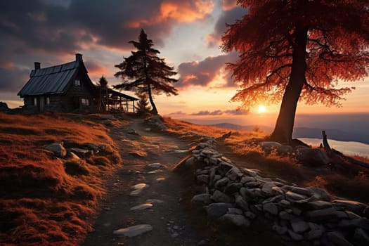 A village house in the mountains in the rays of sunset. Beautiful view of the sunset.
