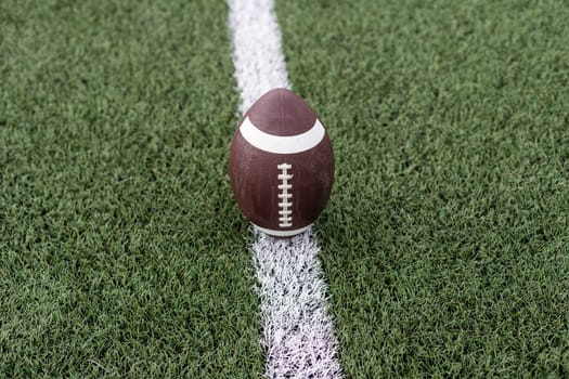 photo american football ball on stadium background. High quality photo