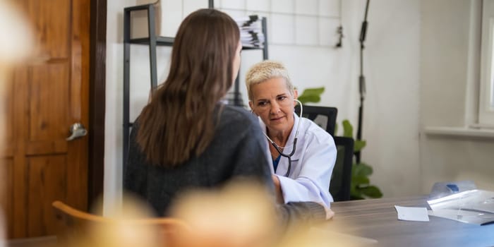 doctor discussion results or symptoms and gives a recommendation to a women patient, giving consultation during medical examination in clinic.