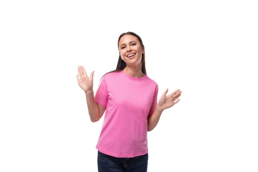 young brunette woman in pink t-shirt on white background with copy space.