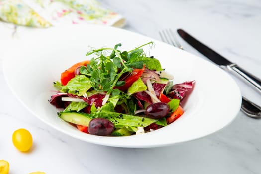 salad of greens, lettuce leaves, cucumbers, pink onions