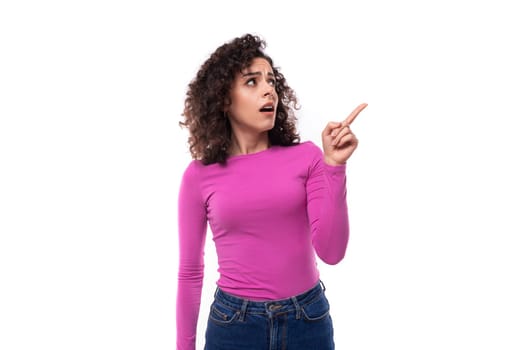 young curly promoter woman dressed in a lilac turtleneck gesturing with her hands.