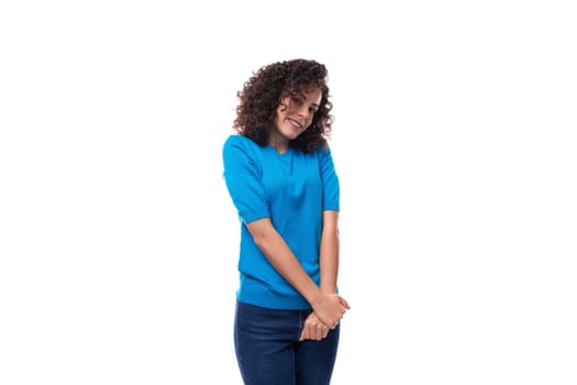 cute young curly brunette woman with shoulder-length hair is wearing a blue t-shirt.