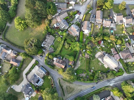 Drone's eye view of houses set amongst fields and trees in Corfe Mullen in Dorset England