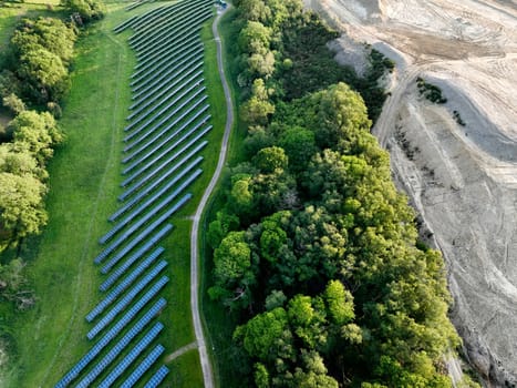 Aerial view of solar panels at a solar farm set amongst the countryside