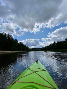 Kayaking on the river Gauja, exploring nature, green kayak boat. High quality photo