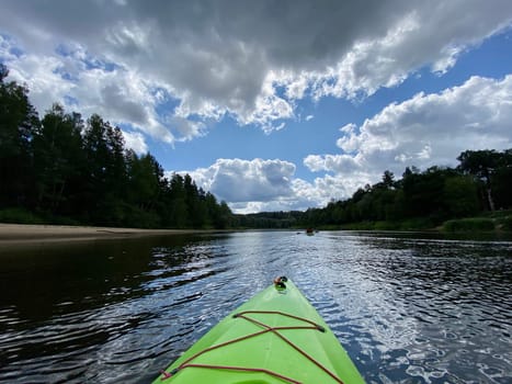 Kayaking on the river Gauja, exploring nature, green kayak boat. High quality photo