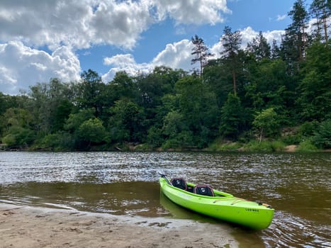 Kayaking on the river Gauja, exploring nature, green kayak boat. High quality photo