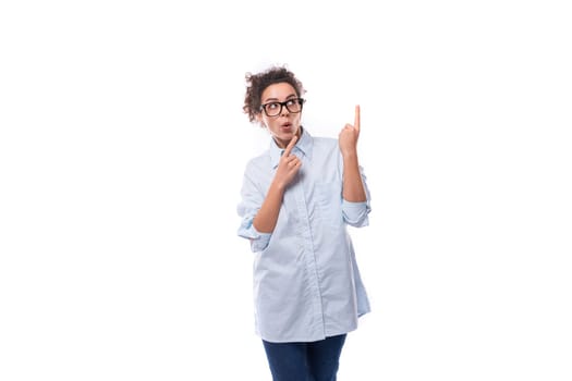 young successful confident leader woman with curly black hair dressed with light blue shirt.