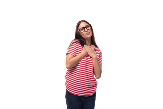 young kind cute european brunette woman with glasses dressed in a summer striped t-shirt on a white background. people lifestyle concept.