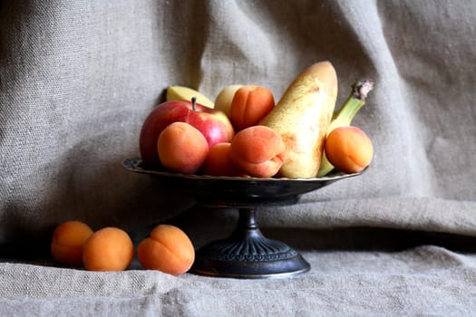 Heap of freshness fruits in  bowl againast nice gray canvas background