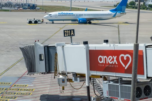 27.06.2023, Antalya Airport, Turkey. The airplane stands at the airport at sunset. The plane is preparing to take off.