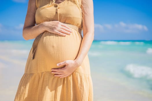 Radiant and expecting, a pregnant woman stands on a pristine snow-white tropical beach, celebrating the miracle of life against a backdrop of natural beauty.