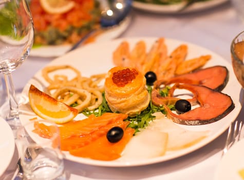 Assorted fish on a plate on festive table