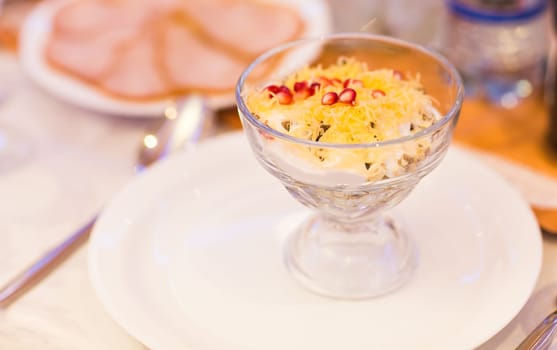 salad with cheese mushrooms and ham on festive table