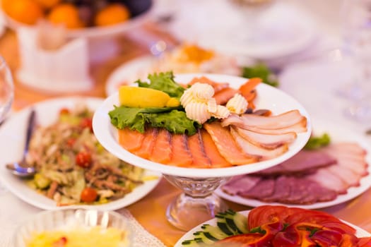 Assorted fish on a plate on festive table