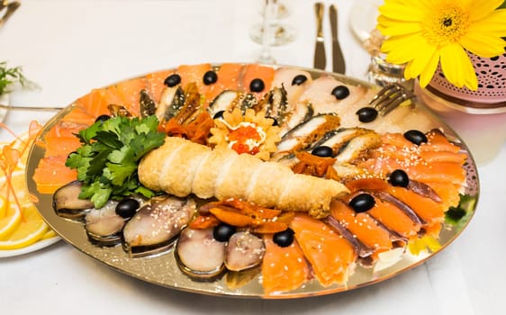 Assorted fish on a plate on festive table