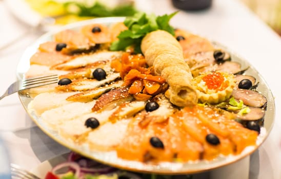 Assorted fish on a plate on festive table