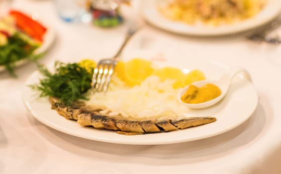 Assorted fish on a plate on festive table