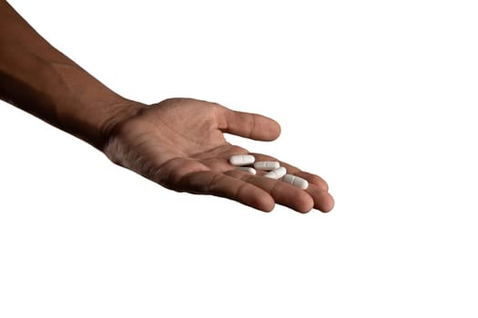 Black male hand holding pills