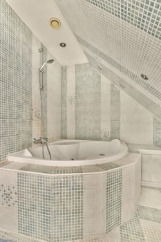 a bathroom with blue and white mosaic tiles on the walls, along with a freestanding bathtub in the corner