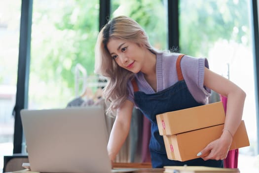 Asian female business owner handles delivery of orders to customers.