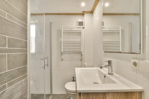 a bathroom with a sink, mirror and towel rack on the wall next to the shower stall is made out of wood