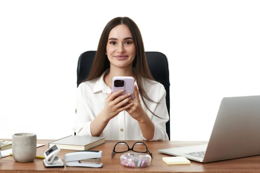 attractive smiling business woman using phone in the office