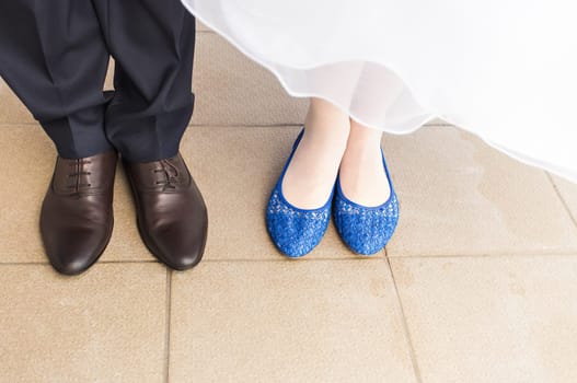 feet of bride and groom, wedding shoes close-up.