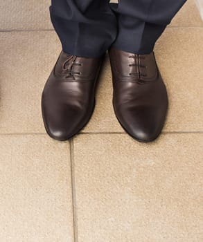 Close-up of businessman feet in black boots on the floor