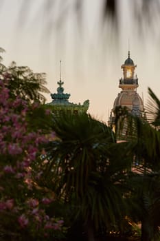 Monaco, Monte-Carlo, 21 October 2022: Square Casino Monte-Carlo at sunny day, a lot of luxury cars, Hotel de Paris, wealth life, tourists take pictures of the landmark, pine trees, blue sky, flowers. High quality 4k footage