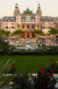 Monaco, Monte-Carlo, 21 October 2022: Square Casino Monte-Carlo at sunny day, a lot of luxury cars, Hotel de Paris, wealth life, tourists take pictures of the landmark, pine trees, blue sky, flowers. High quality 4k footage